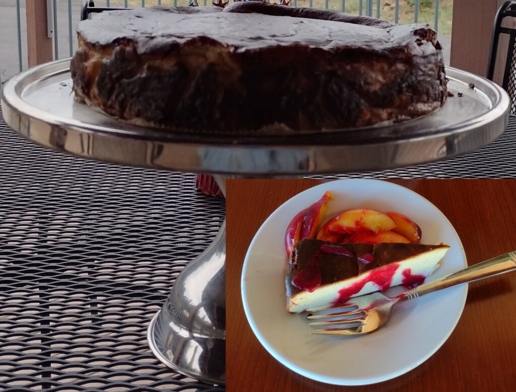 photo of uncut cheese cake on cake stand with insert of slice with peaches and raspberry sauce.